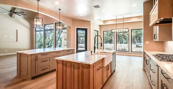Luxury chef's kitchen with custom cabinetry, oversized island, professional-grade appliances, and open-concept design for entertaining.