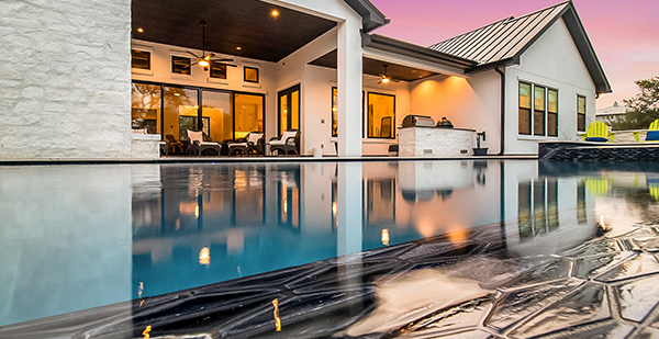 Luxury custom home with infinity edge pool and panoramic Hill Country sunset views in Spring Branch TX