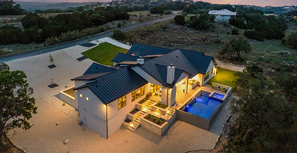 Modern Texas Hill Country custom home with oversized front porch and contemporary architectural details